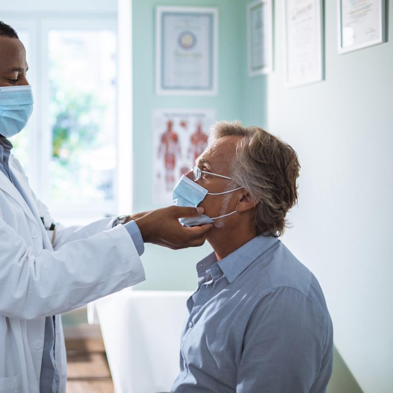 A male doctor examining a male patient.