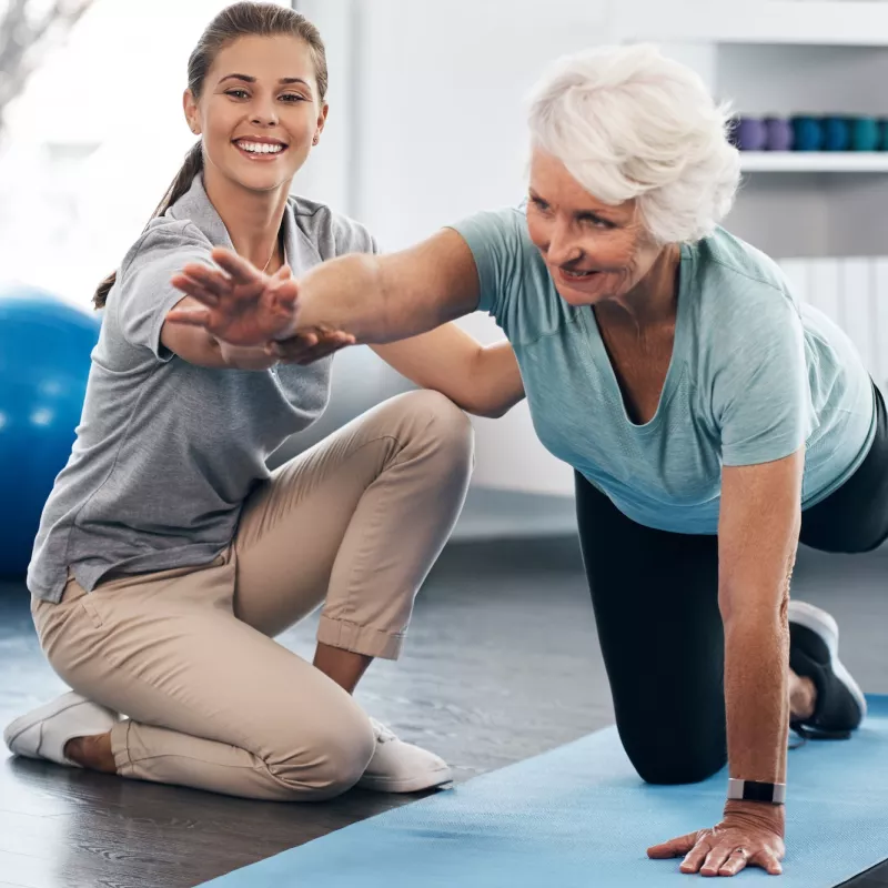 A woman works with a physical therapist.